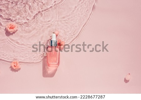 Cosmetic bottle with serum, rose oil, transparent water background with flowers
