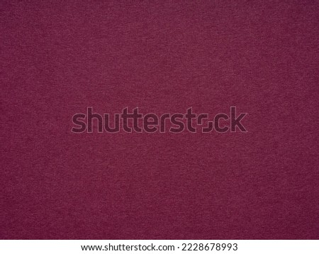 Maroon paper texture, abstract background. The name of the color is burgundy. Blank page sheet decor. Background for handcrafts, new year designs decoration, text, lettering, wall screen saver. Royalty-Free Stock Photo #2228678993