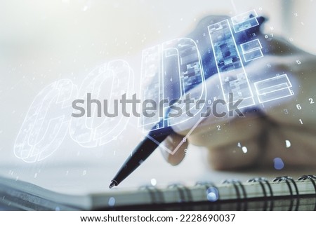 Creative Code word sign and woman hand writing in notepad on background, international software development concept. Multiexposure