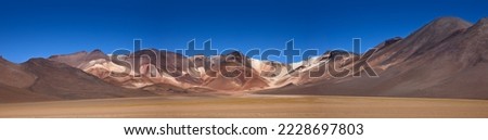 Panorama of The colourful Andes mountain range in the Salvador Dali Desert (Desierto de Salvador Dali) in the Altiplano region of Bolivia. Royalty-Free Stock Photo #2228697803