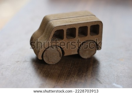 small wooden brown toy bus