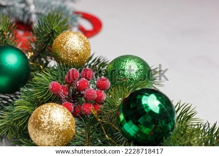 beautiful branches of a Christmas tree with cones and toys on a white wooden background close-up