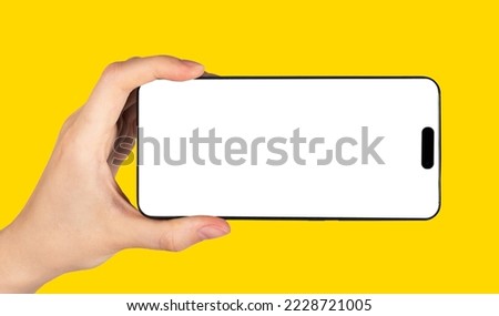 Phone screen mockup in hand with horizontal orientation for video. High quality photo