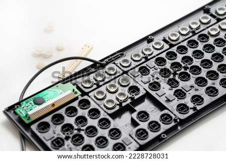 repair, cleaning the keyboard. disassembled black keyboard, rubber white caps, microcircuit. keyboard details.