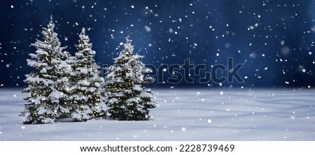 Artistic Winter Christmas background with snowy Christmas tree. Christmas trees decorated with Christmas lights in night. Beautiful Winter Holiday Template With Copy Space for design
