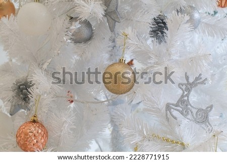White Christmas tree decoration with balls on fir branches. Christmas holiday decorations. Festive decorated home interior