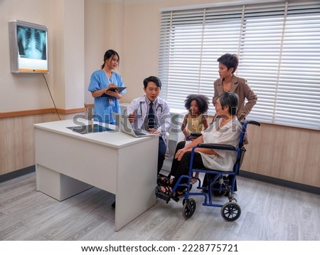 At hospital room patient sit on wheel chair looking x-ray film and listen doctor explanation