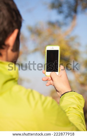 Close up of a man makes photo with a mobile smart phone  