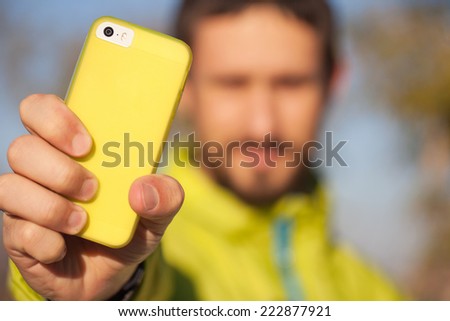 Close up of a man with a mobile smart phone  
