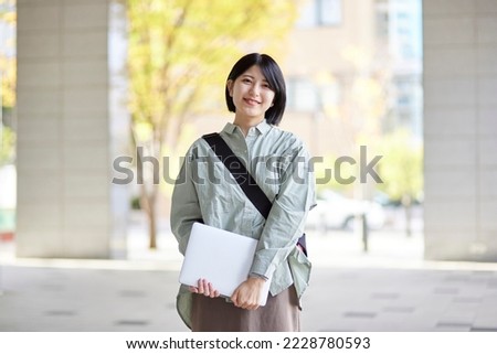 Young Japanese college student enjoying campus life