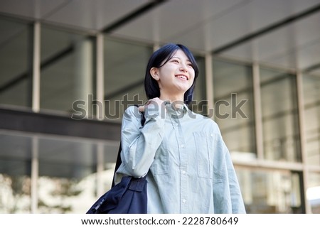 Young Japanese college student enjoying campus life Royalty-Free Stock Photo #2228780649