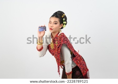 Portrait asian pretty woman show credit card posing with smiling in Thai northeastern dress costume,  looking camera on white background