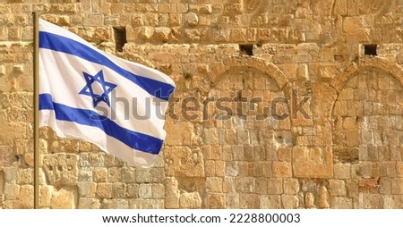 Israeli flag at the Western Wall, Jerusalem , Israel, copy space. Royalty-Free Stock Photo #2228800003
