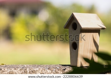This is a picture of a lovely birdhouse in garden.