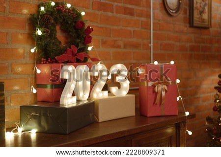 Christmas Gift boxes and decorated on small wooden table in living room.