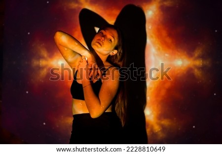 A beautiful model dances against the backdrop of an abstraction projector. Abstract figure and girl.