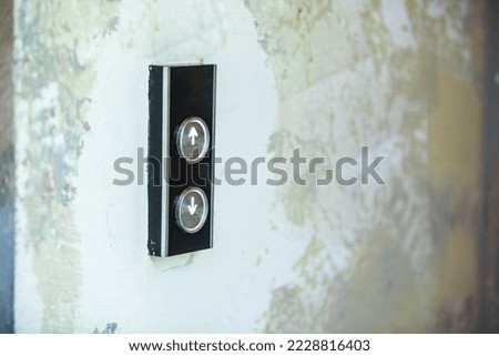 lift elevator buton up or down black and silver round key light inside office building