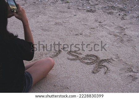 Young woman take a selfie on the beach