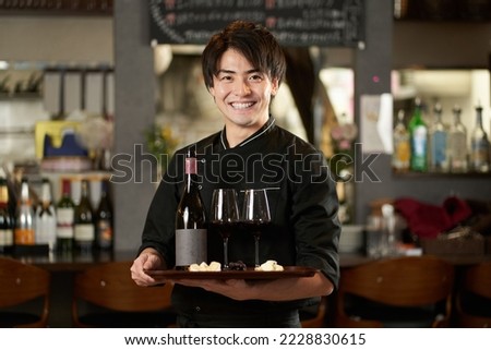Asian man working in a restaurant Royalty-Free Stock Photo #2228830615