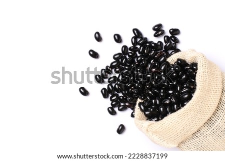 Black bean in sack bag isolated on white background. Top view. Flat lay. Royalty-Free Stock Photo #2228837199