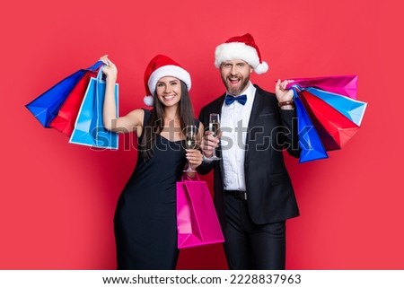 happy new year to glad couple with shopping bags in studio. shopping couple at new year sale
