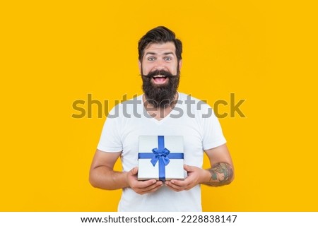 present box for amazed man in shirt. birthday man holding present box. bearded man