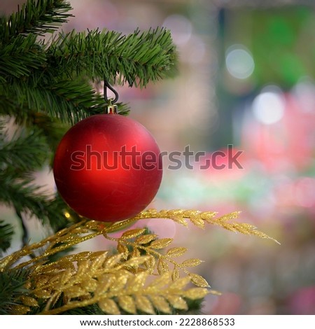 Ornaments and lights on the decorated Christmas tree. 
 Colorful balls garland glowing lamps on the branches are sprinkled with snow.Festive traditional seamless background for the New Year.