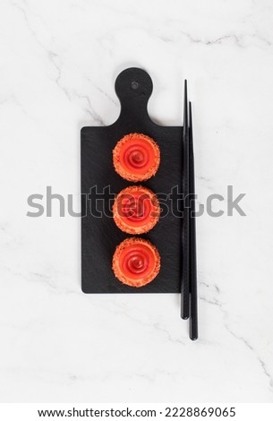 Vegan Tomato mousse cream appetizer of round cylindrical shape with tourbillon jelly, on a serving board. White background. Top view