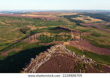 Beautiful late Summer aerial drone landscape image of heather in full bloom in Peak District
