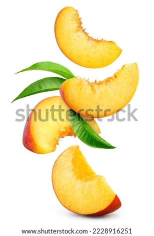 Peach isolated. Peach slices flying on white background. Falling peach pieces with leaf. Full depth of field.
