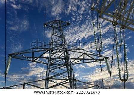 Electricity pylon (high voltage power line) on the background of the cloudy sky  