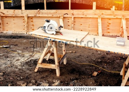 Hand held circular saw on workbench Royalty-Free Stock Photo #2228922849