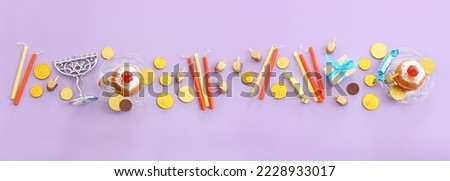 Religion image of jewish holiday Hanukkah background with menorah (traditional candelabra), doughnut and candles Royalty-Free Stock Photo #2228933017