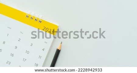 close up white calendar 2023 month schedule with pencil to make appointment meeting or manage timetable each day lay on white background for planning work and life concept