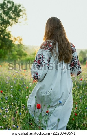 Woman in traditional dress scenic photography. Poppy field. Picture of lady with beautiful nature on background. High quality wallpaper. Photo concept for ads, travel blog, magazine, article