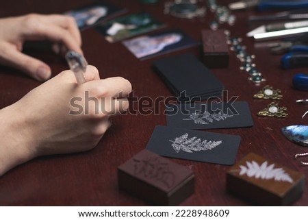 Close up writing cards concept photo. Small business. Packaging process. Side view photography with printed cards on background. High quality picture for wallpaper, travel blog, magazine, article