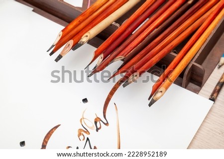 A set of calligraphy reeds. Calligraphy reeds (qalam) covered in ink against. Arabic and Persian calligraphy pen. Islamic background of tools for quran calligraphy