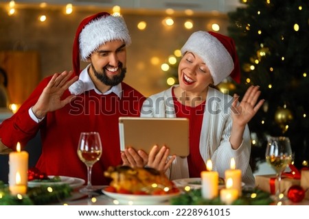 Merry Christmas. Happy loving couple is having dinner at home. Celebration holiday and togetherness near tree.