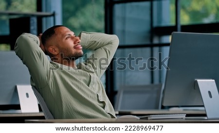 African American business guy man office worker manager entrepreneur man businessman company CEO boss programmer takes break to relieve stress satisfied finish work relax holding hands behind head Royalty-Free Stock Photo #2228969477