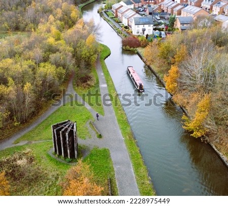 Narrowboat passing the locks memorial on the Leeds Liverpool canal 