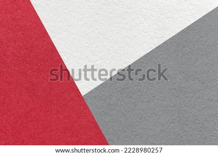 Texture of craft white, red and gray shade color paper background, macro. Structure of vintage wine abstract cardboard with geometric shape and gradient. Felt backdrop closeup.