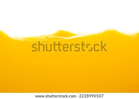 Close up bright orange juice texture for health and nature waves Royalty-Free Stock Photo #2228990507
