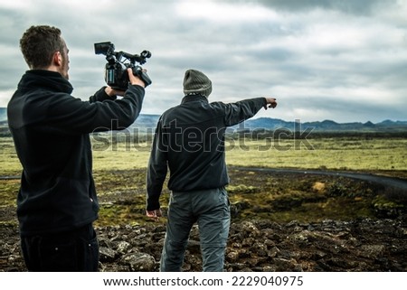 Cameraman filming in the scenic Iceland