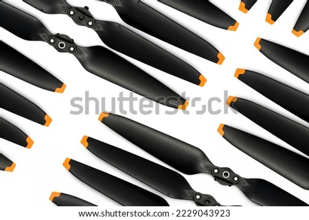 Top view of drone propeller blades on white. Drone propellers made from plastic carbon fiber. Spare propeller. Drone accessories. UAV carbon fiber propellers. Carbon fiber reinforced polymer material. Royalty-Free Stock Photo #2229043923