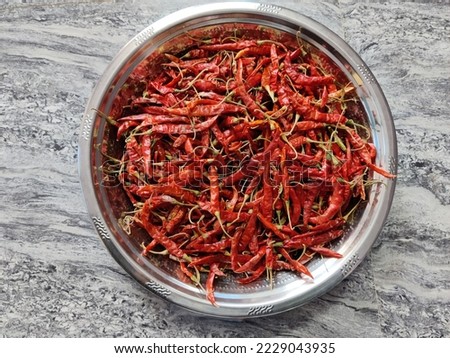 select a focus picture of a container full of dried red chillies