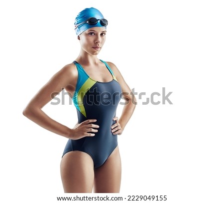 Focussed on swimming. Cropped portrait of a young female swimmer isolated on white. Royalty-Free Stock Photo #2229049155