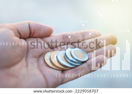 Design of a hand of a young thin man holding with his palm Mexican coins of ten pesos with numbers and economic statistics