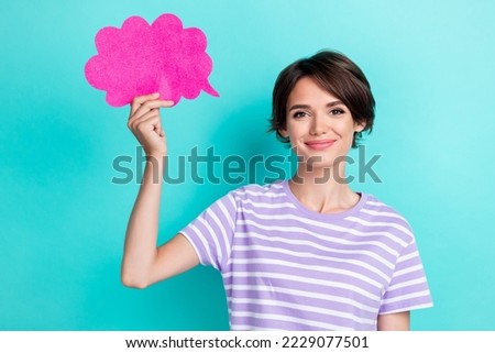 Portrait of good mood pretty girl with bob hairdo wear striped t-shirt hand hold pink paper cloud isolated on turquoise color background