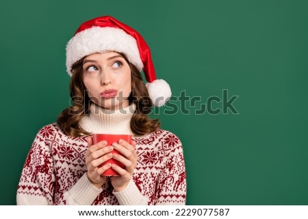 Photo of peaceful minded lady arms hold coffee mug look interested empty space isolated on green color background