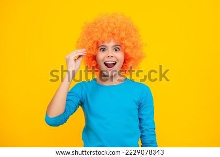 Girls birthday party. Funny kid in curly redhead wig. Time to have fun. Teen girl with orange hair, being a clown. Excited teenager, glad amazed and overjoyed emotions.